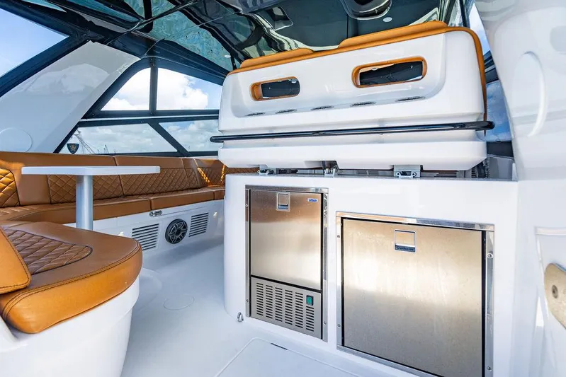  Yacht Photos Pics Luxurious interior of 2021 Intrepid 477 Evolution yacht with leather seating and modern amenities.