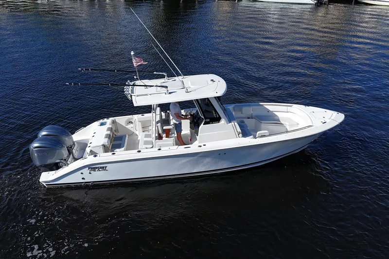  Yacht Photos Pics 2022 Pursuit S 288 Sport boat on water, featuring dual engines and fishing rods.
