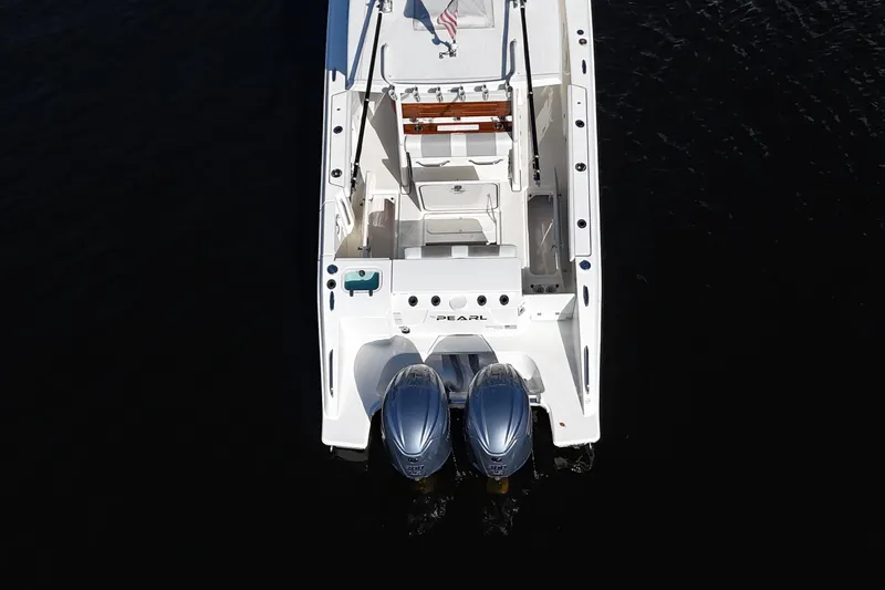  Yacht Photos Pics 2022 Pursuit S 288 Sport boat with dual engines, viewed from above on dark water.