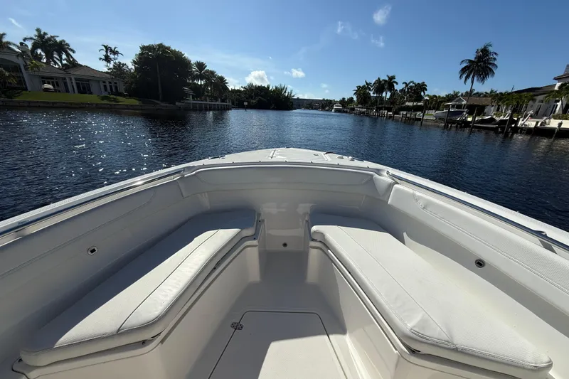 Yacht Photos Pics Bow view of 2022 Pursuit S 288 Sport boat on a sunny river.