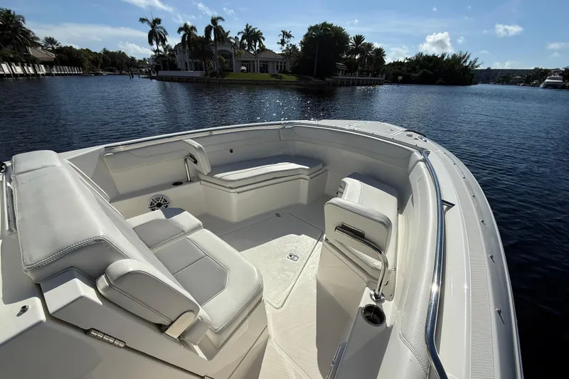  Yacht Photos Pics 2022 Pursuit S 288 Sport boat interior with luxurious seating on a sunny day.