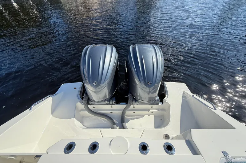 Yacht Photos Pics 2022 Pursuit S 288 Sport boat with dual outboard engines on water.