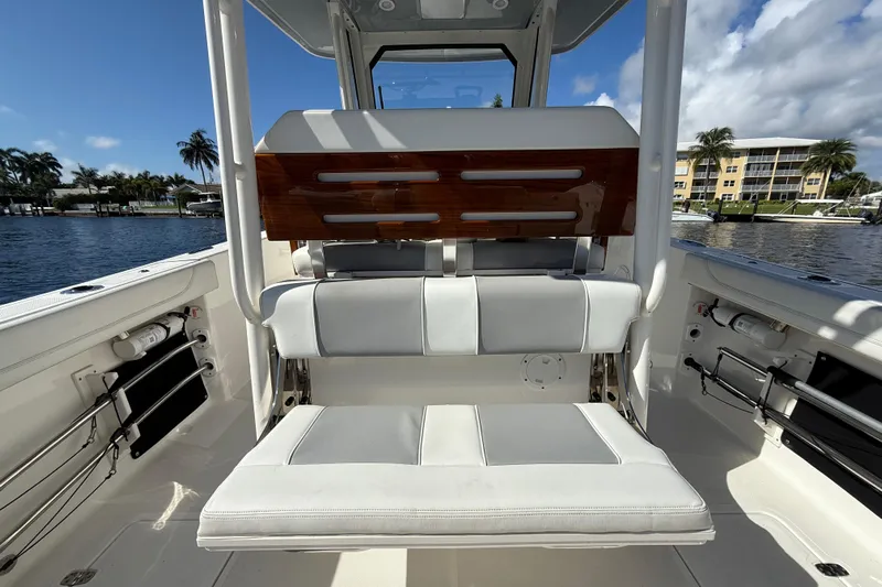  Yacht Photos Pics 2022 Pursuit S 288 Sport boat interior with white seating and wooden accents.