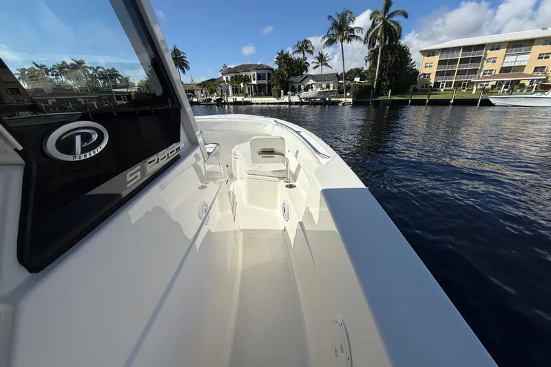  Yacht Photos Pics 2022 Pursuit S 288 Sport boat docked by waterfront homes and palm trees.