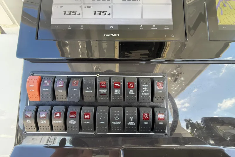  Yacht Photos Pics Control panel of a 2022 Pursuit S 288 Sport boat with Garmin display and switches.