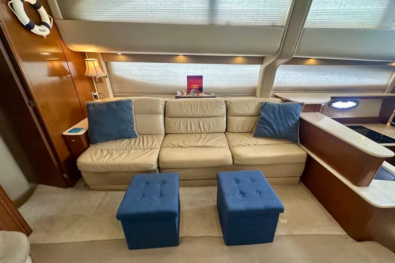  Yacht Photos Pics Luxurious interior of 2005 Meridian 459 Motoryacht with beige sofa and blue ottomans.