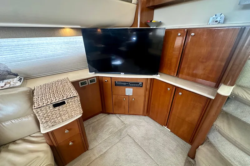  Yacht Photos Pics Luxurious interior of 2005 Meridian 459 Motoryacht with TV and wooden cabinetry.