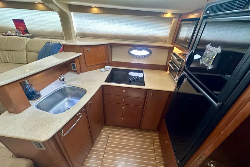  Yacht Photos Pics 2005 Meridian 459 Motoryacht kitchen with modern appliances and wooden cabinetry.