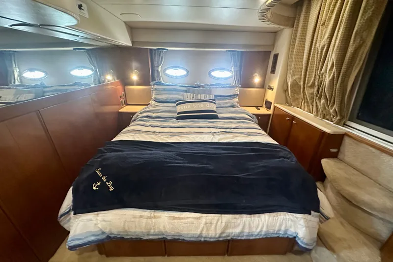  Yacht Photos Pics Luxurious bedroom interior of 2005 Meridian 459 Motoryacht with cozy bedding and elegant wood finishes.