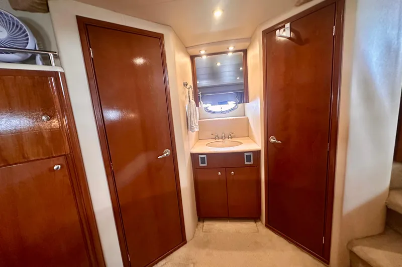  Yacht Photos Pics 2005 Meridian 459 Motoryacht interior with wooden cabinetry and sink area.