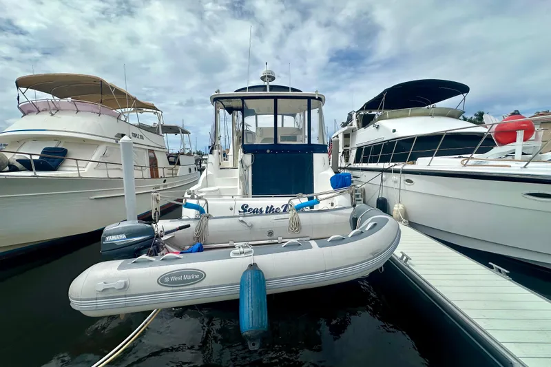  Yacht Photos Pics 2005 Meridian 459 Motoryacht docked with inflatable dinghy, surrounded by other boats.