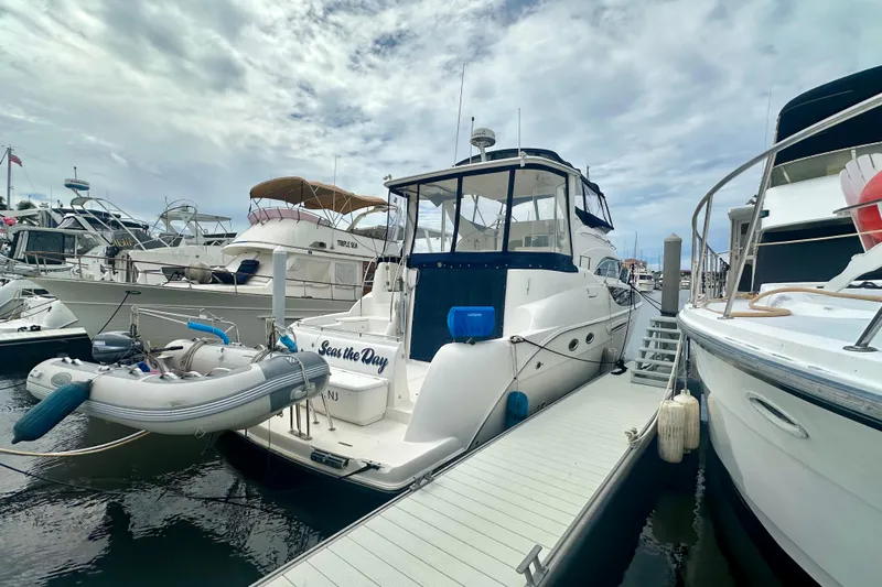  Yacht Photos Pics 2005 Meridian 459 Motoryacht docked at marina, surrounded by other boats.