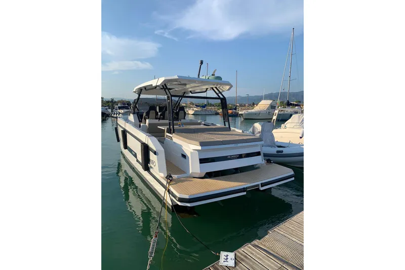  Yacht Photos Pics 2024 DE ANTONIO D32 luxury yacht docked in marina under clear blue sky.