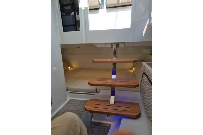  Yacht Photos Pics Interior of 2024 DE ANTONIO D32 boat with wooden steps and modern design.