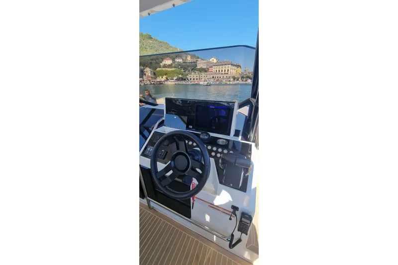  Yacht Photos Pics Cockpit view of 2024 De Antonio Yachts D32, featuring modern steering and controls.