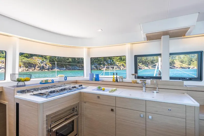  Yacht Photos Pics Modern kitchen interior of 2025 Lagoon 43 yacht with scenic ocean view.