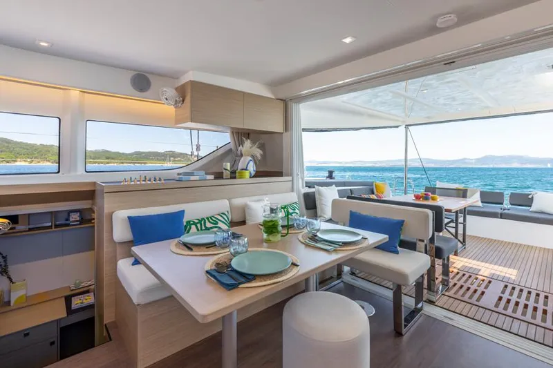  Yacht Photos Pics Luxurious Lagoon 43 yacht interior with dining area, ocean view, and modern decor, 2025 model.