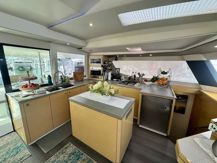  Yacht Photos Pics Luxurious kitchen interior of 2015 Fountaine Pajot SABA 50 catamaran, featuring modern amenities.