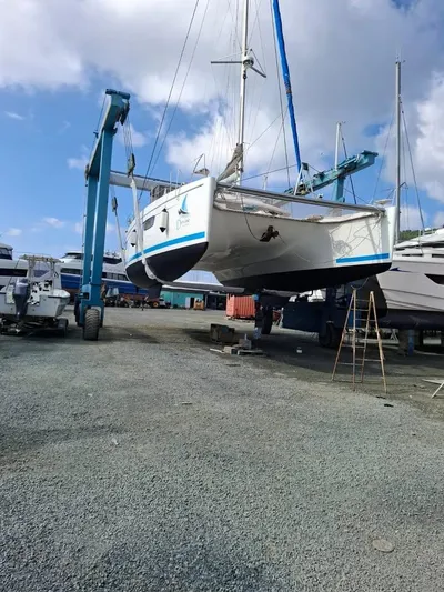  Yacht Photos Pics 2015 Fountaine Pajot SABA 50 catamaran being lifted in a boatyard.