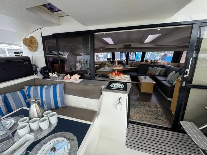  Yacht Photos Pics Luxurious interior of 2015 Fountaine Pajot SABA 50 catamaran with elegant seating and dining area.