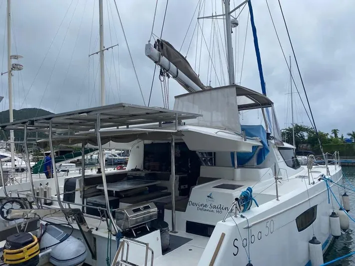  Yacht Photos Pics 2015 Fountaine Pajot SABA 50 catamaran docked at marina, overcast sky.