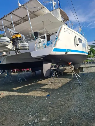  Yacht Photos Pics 2015 Fountaine Pajot SABA 50 catamaran on dry dock, showcasing hull and propellers.