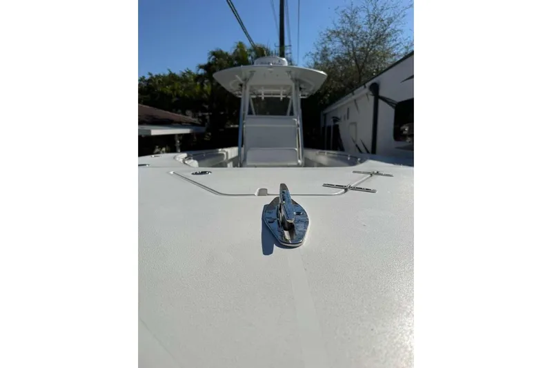  Yacht Photos Pics 2022 Contender 35 ST boat deck with cleat, sunny day, trees in background.
