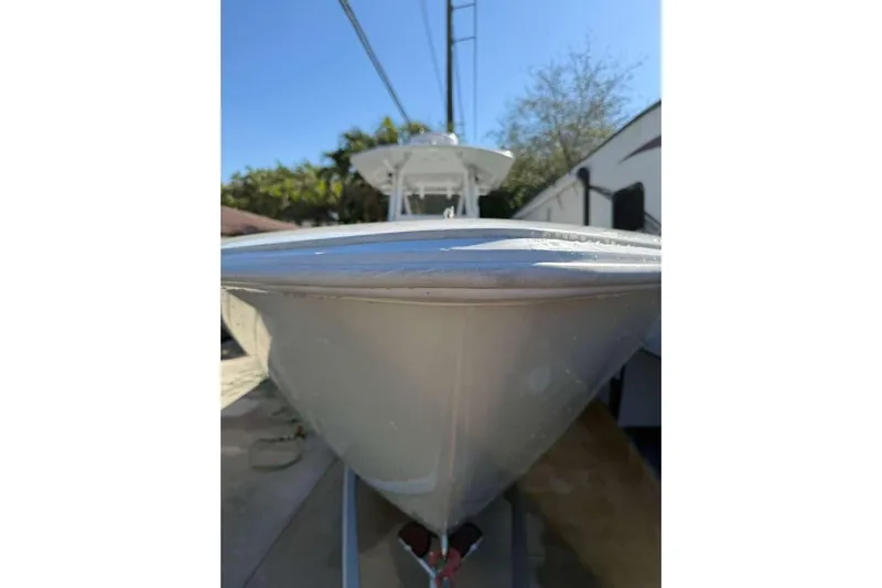  Yacht Photos Pics 2022 Contender 35 ST boat, sleek design, parked outdoors under clear blue sky.