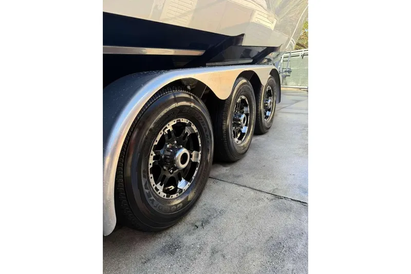  Yacht Photos Pics Triple-axle trailer with sleek black wheels for 2022 Contender 35 ST boat.
