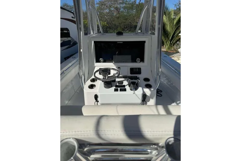  Yacht Photos Pics 2022 Contender 35 ST boat console with steering wheel and navigation equipment.