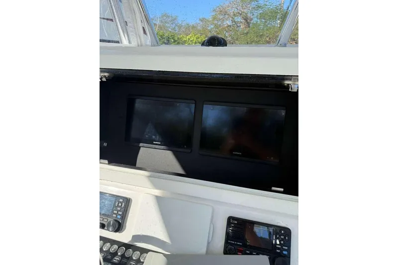  Yacht Photos Pics 2022 Contender 35 ST boat dashboard with dual Garmin displays and control panel.