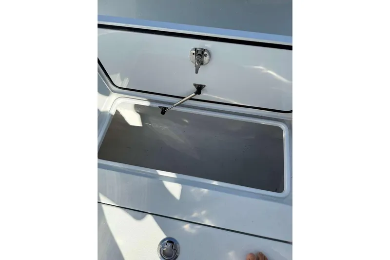  Yacht Photos Pics Open storage compartment on 2022 Contender 35 ST boat, featuring secure latch mechanism.