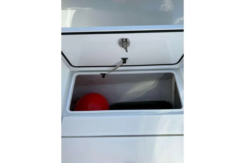  Yacht Photos Pics Open storage compartment in 2022 Contender 35 ST boat with red buoy inside.