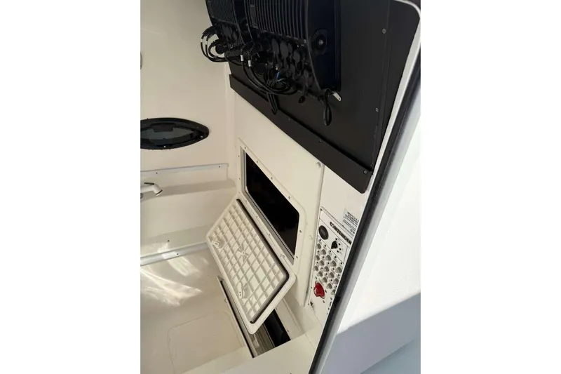  Yacht Photos Pics 2022 Contender 35 ST boat interior with open storage compartment and control panel.