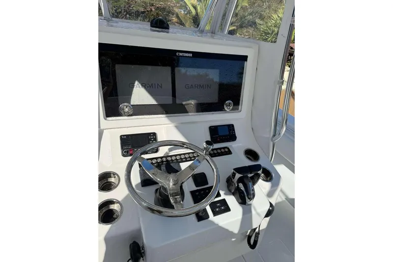  Yacht Photos Pics 2022 Contender 35 ST boat dashboard with Garmin navigation system and steering wheel.