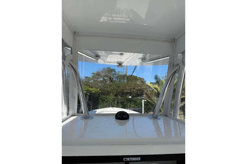  Yacht Photos Pics 2022 Contender 35 ST boat interior with clear windshield and scenic outdoor view.