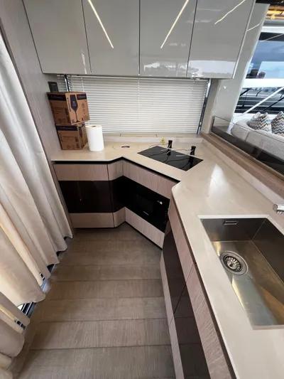  Yacht Photos Pics Modern kitchen in 2025 Absolute NAVETTA 48 yacht with sleek cabinetry and appliances.