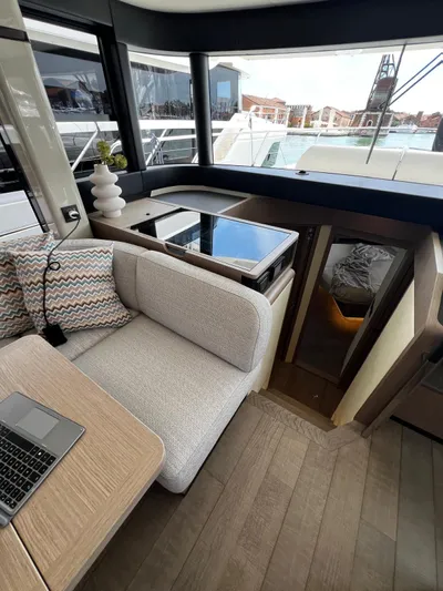  Yacht Photos Pics Interior of 2025 Absolute NAVETTA 48 yacht with modern seating and table setup.