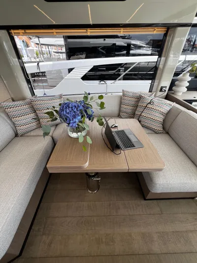  Yacht Photos Pics Luxurious interior of 2025 Absolute NAVETTA 48 yacht with elegant seating and table decor.