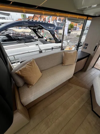  Yacht Photos Pics Interior of 2025 Absolute NAVETTA 48 yacht with cozy seating and large window view.