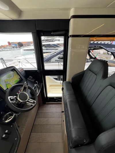  Yacht Photos Pics Interior view of 2025 Absolute NAVETTA 48 yacht, featuring sleek seating and modern navigation controls.