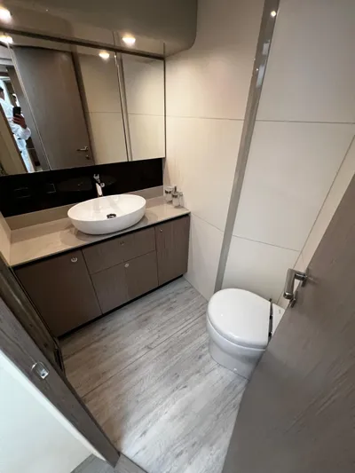  Yacht Photos Pics Modern bathroom in 2025 Absolute NAVETTA 48 yacht with sleek fixtures and wood accents.