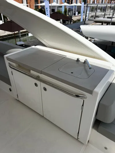  Yacht Photos Pics Outdoor kitchenette on 2025 Absolute NAVETTA 48 yacht, featuring sink and storage cabinets.