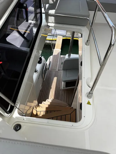  Yacht Photos Pics 2025 Absolute NAVETTA 48 yacht interior with wooden stairs and seating area.