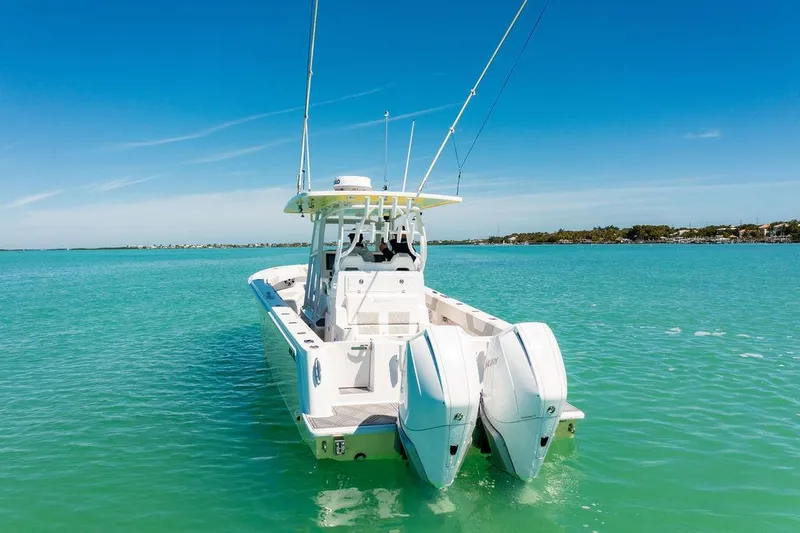 Showgirl Yacht Photos Pics 2023 Reef Runner 340 Center Console boat on turquoise water under clear blue sky.
