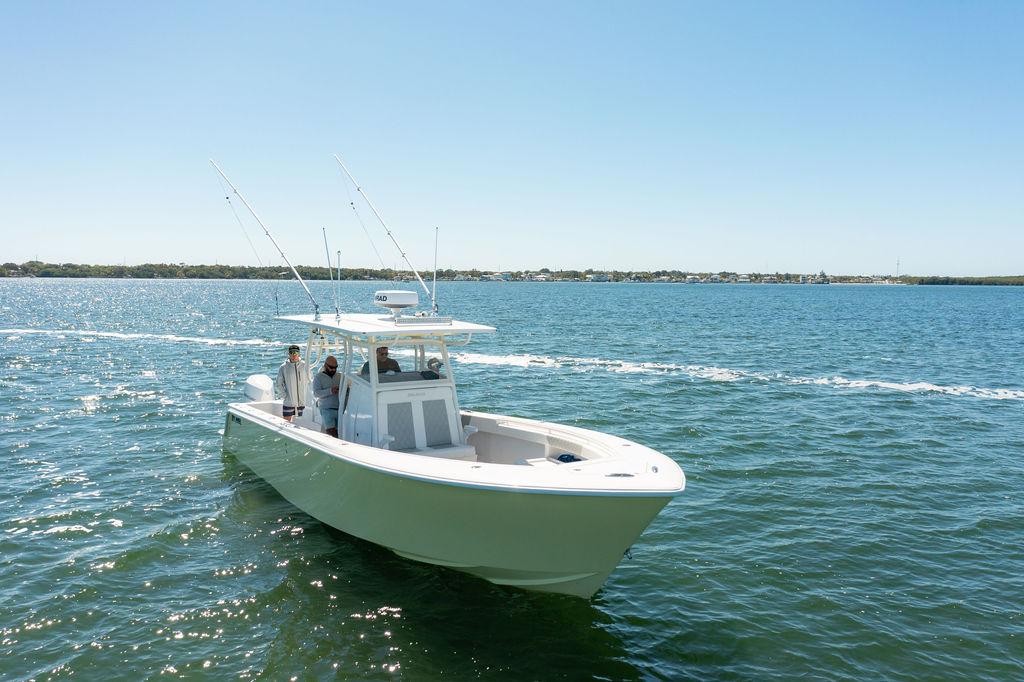2023 Reef Runner 340 Center Console boat cruising on open water under clear skies.