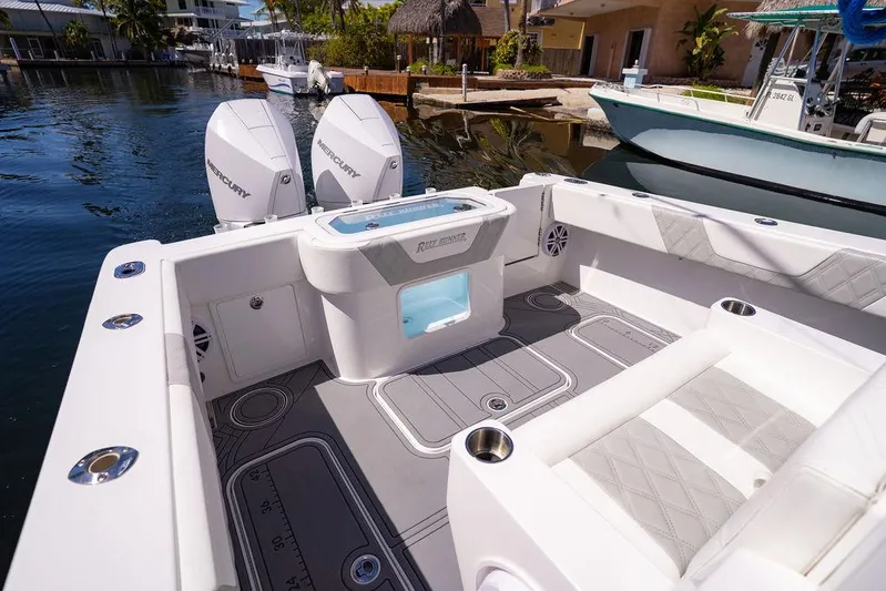 Showgirl Yacht Photos Pics 2023 Reef Runner 340 Center Console boat interior with dual engines, docked in a marina.
