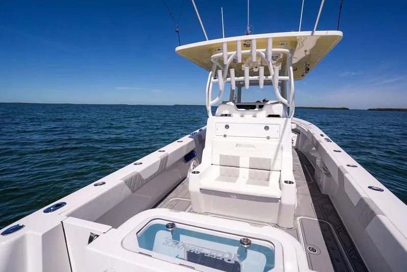 Showgirl Yacht Photos Pics 2023 Reef Runner 340 Center Console boat on open water, showcasing sleek design and spacious deck.