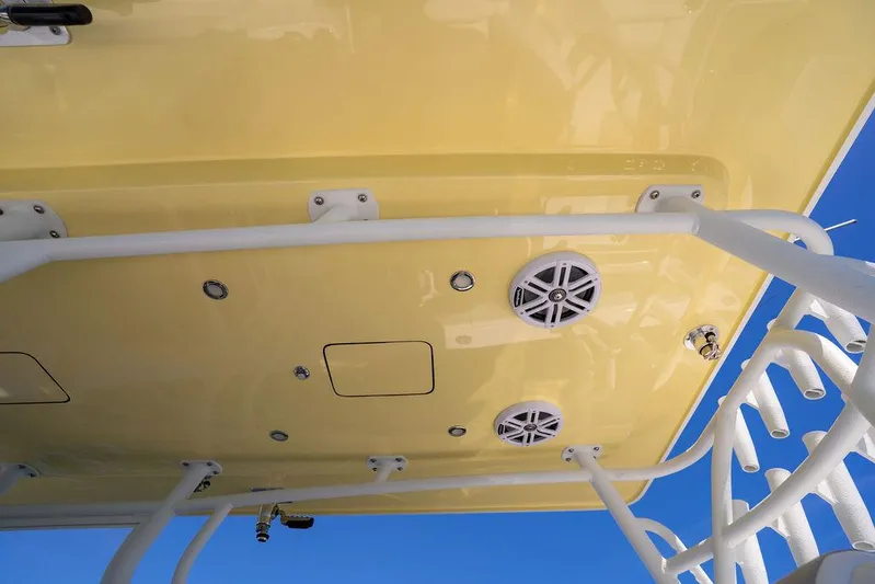 Showgirl Yacht Photos Pics 2023 Reef Runner 340 Center Console boat with yellow canopy and speakers, viewed from below.