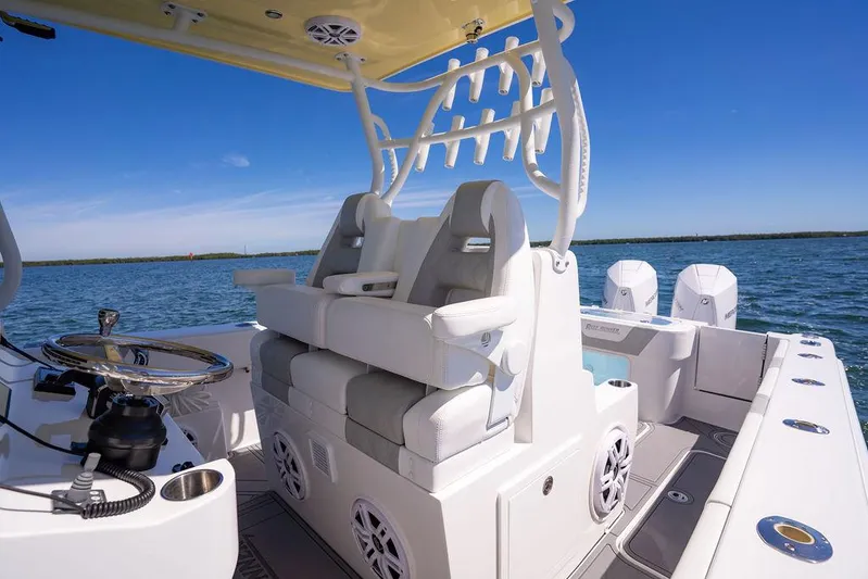 Showgirl Yacht Photos Pics 2023 Reef Runner 340 Center Console boat interior with seating and steering wheel on open water.